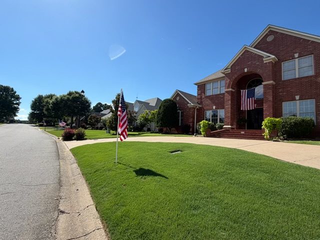 American flags lining the street in front of neighborhood homes