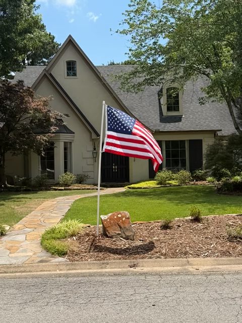 Installed American flag standing in a front yard